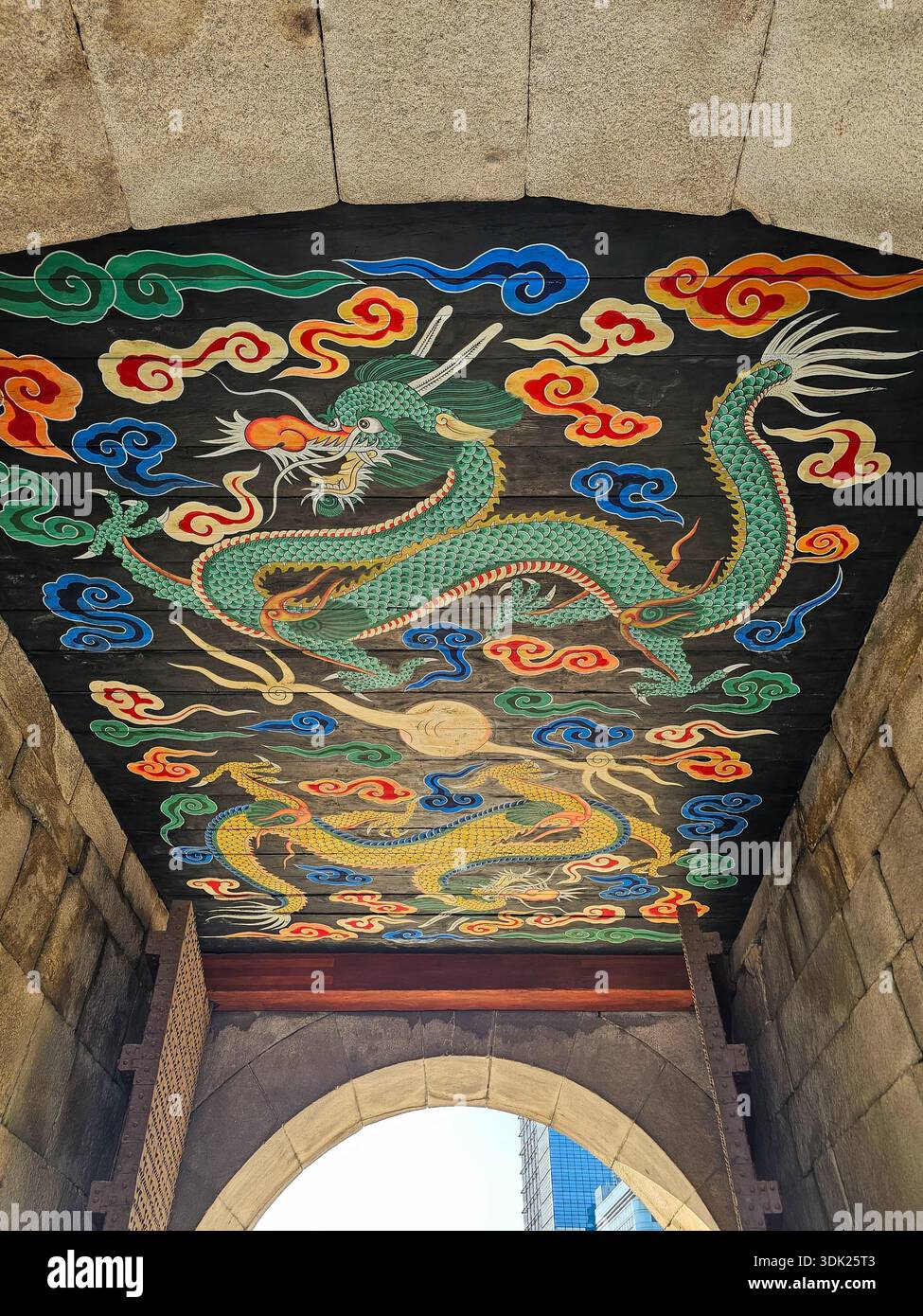 Seoul, South Korea - 3.1.2026: Traditional Dancheong art on a historic Korean palace gate ceiling. Features green and golden dragons in vibrant clouds - Smartphone Captured Stock Image