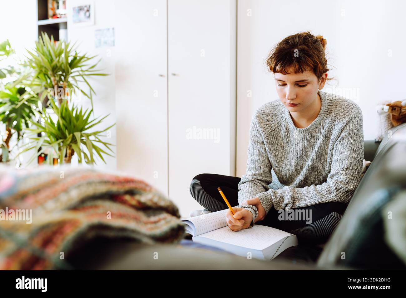 young woman writing notebook Stock Photo