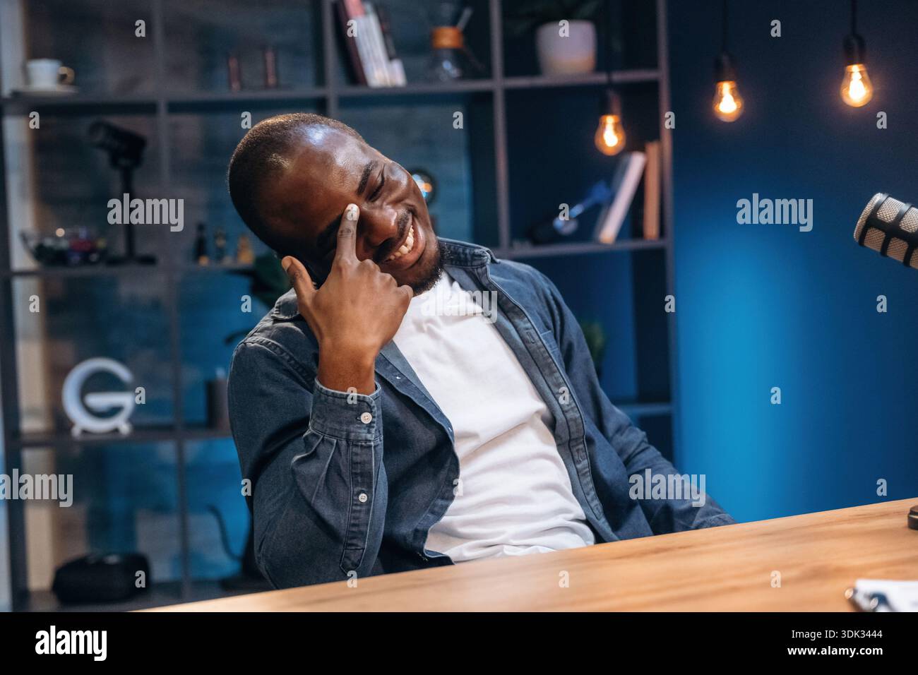 Black man is doing podcast in the studio. Stock Photo