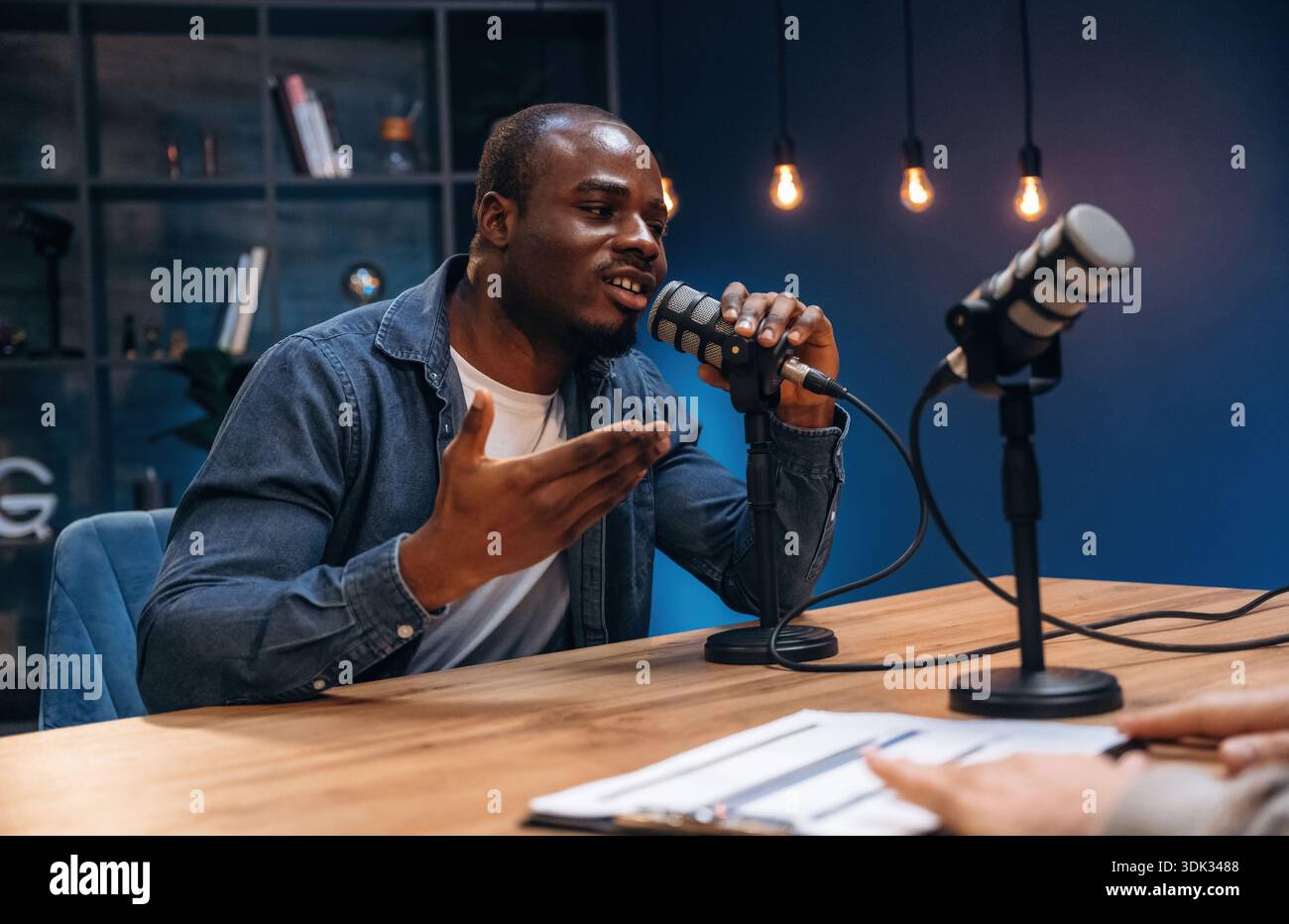 Black man is doing podcast in the studio. Stock Photo