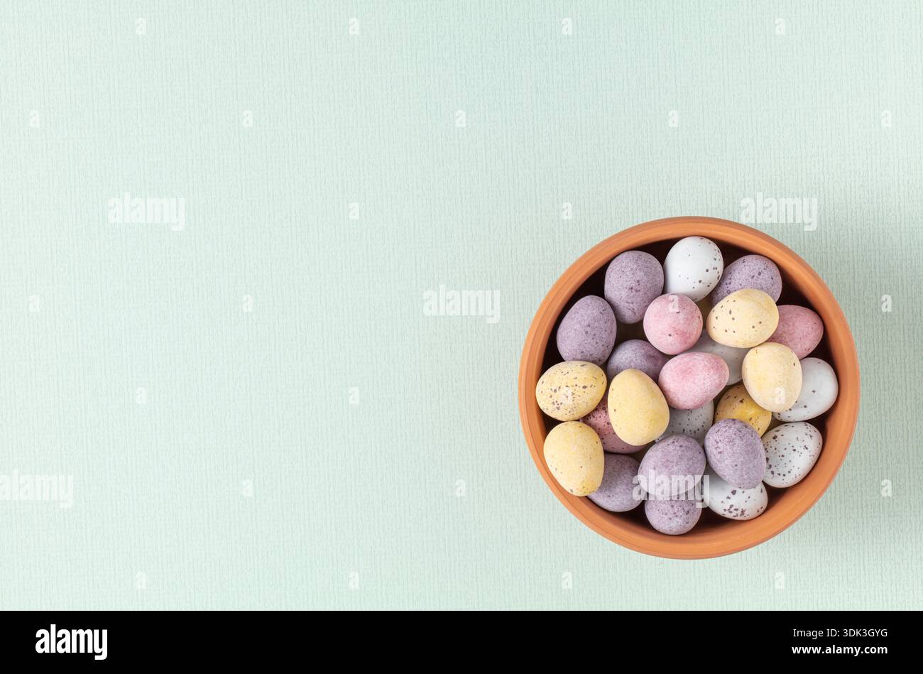 Speckled assorted mini chocolate eggs in bowl Stock Photo