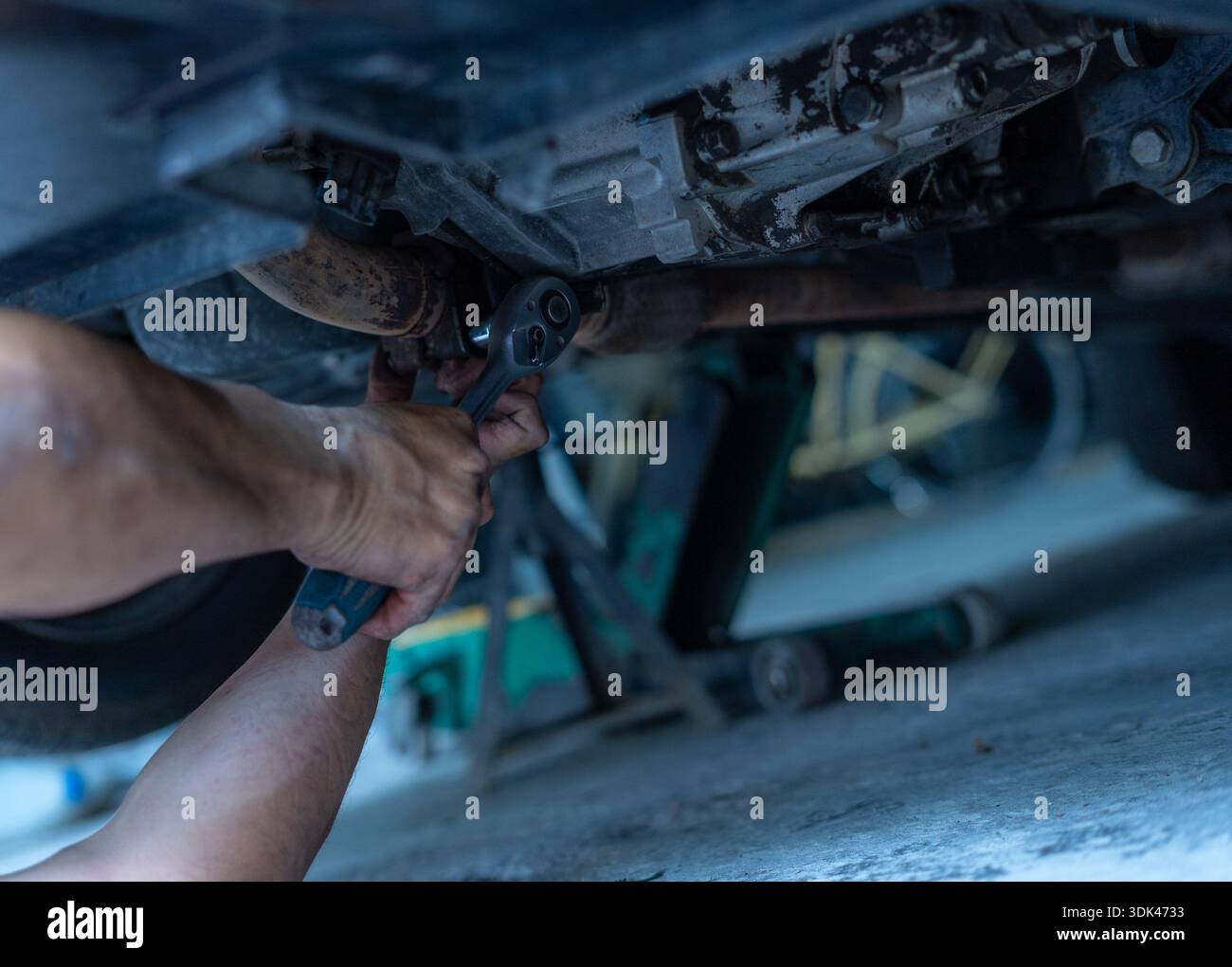 Mechanic repairing car engine with wrench Stock Photo - Alamy