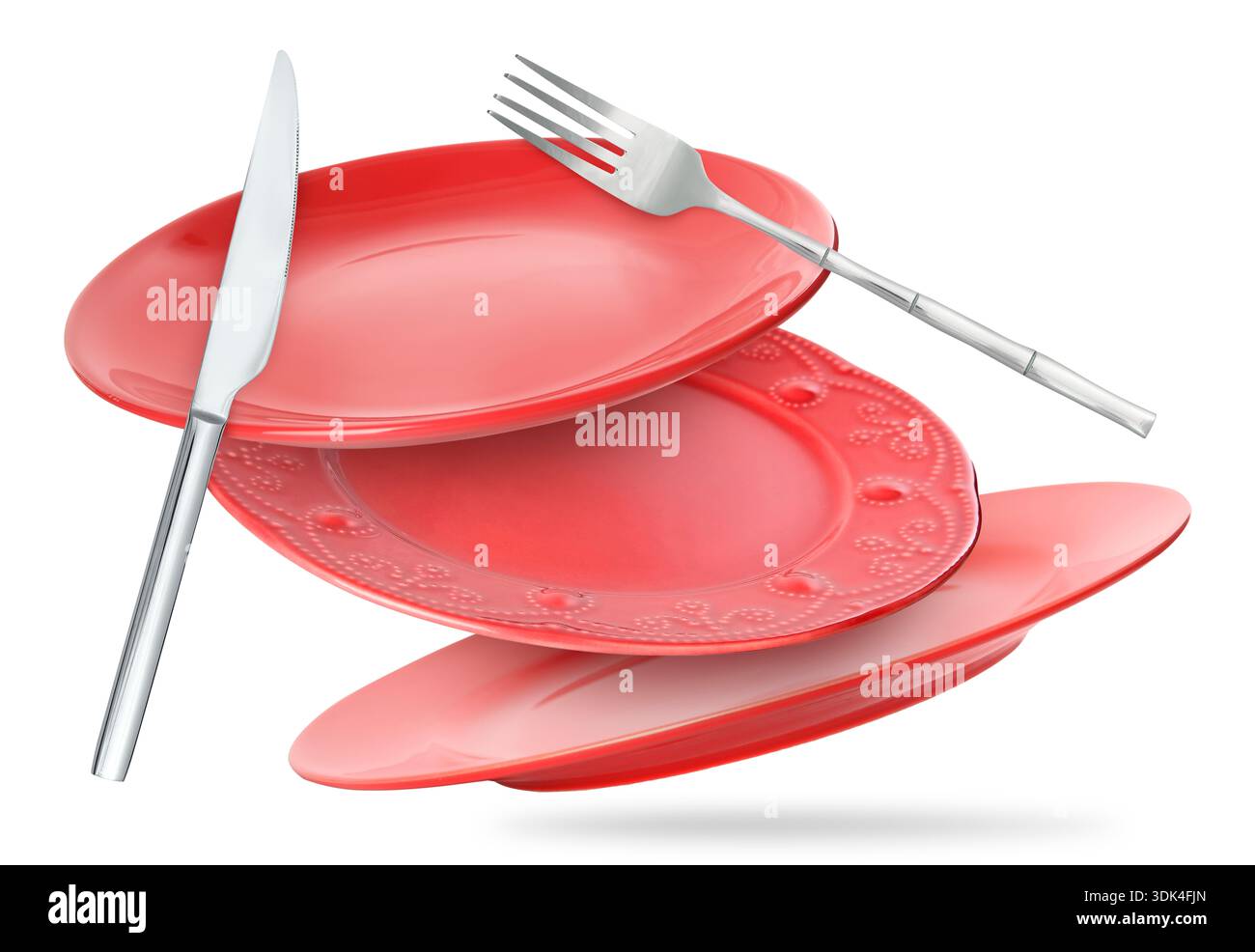 Plates, fork and knife falling on white background Stock Photo