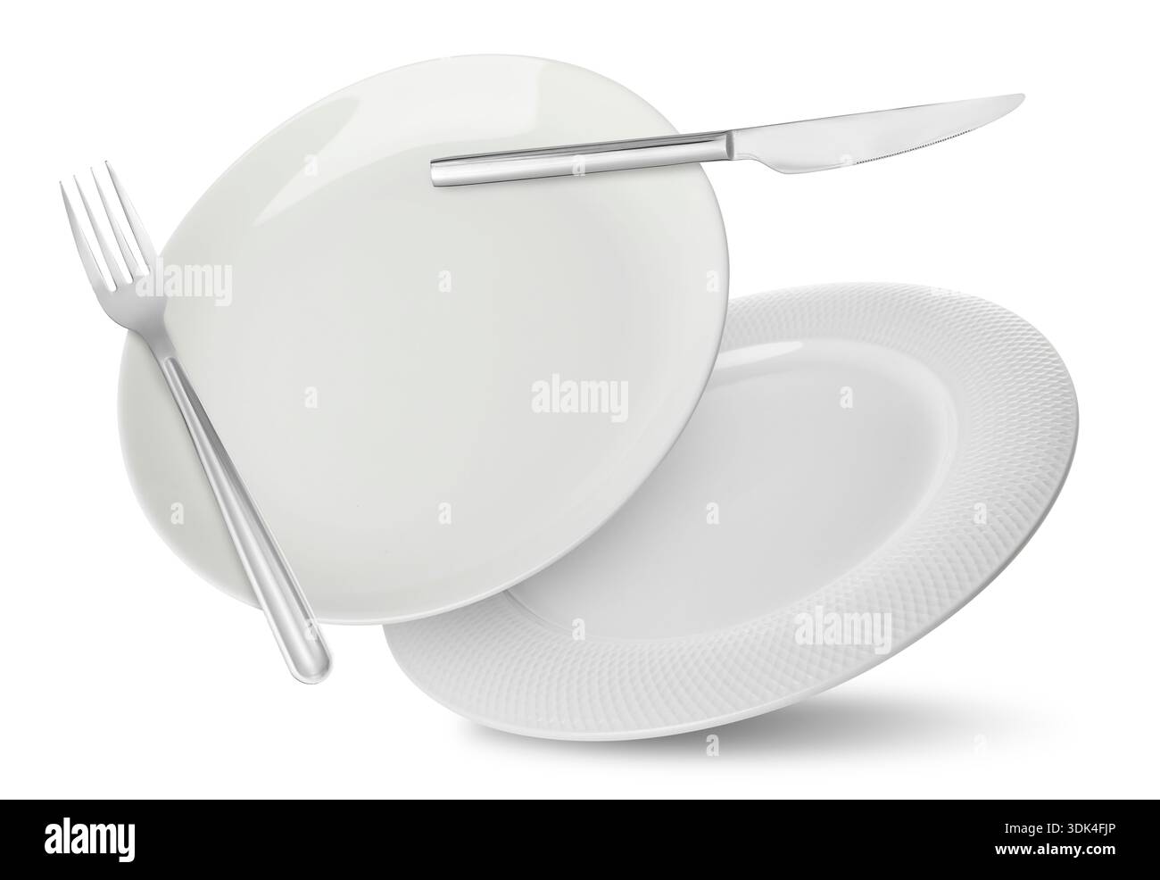 Plates, fork and knife falling on white background Stock Photo
