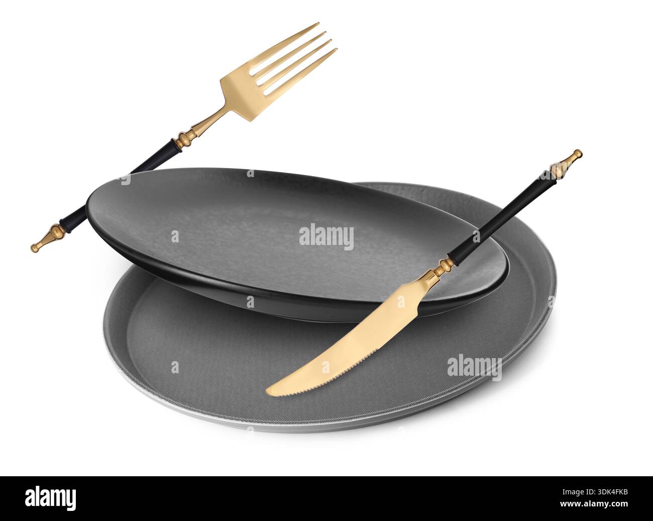 Plates, fork and knife falling on white background Stock Photo