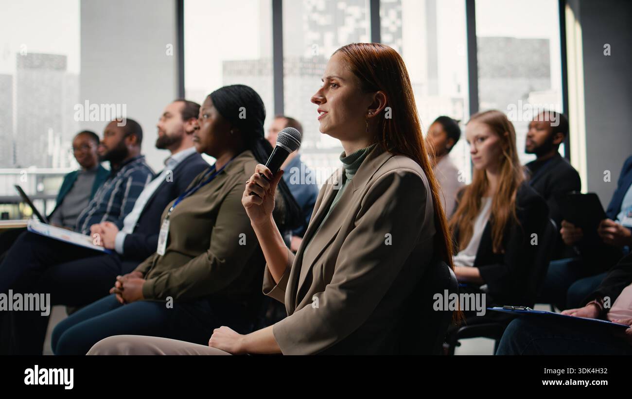 Female participant raising hand engaging hi-res stock photography and ...