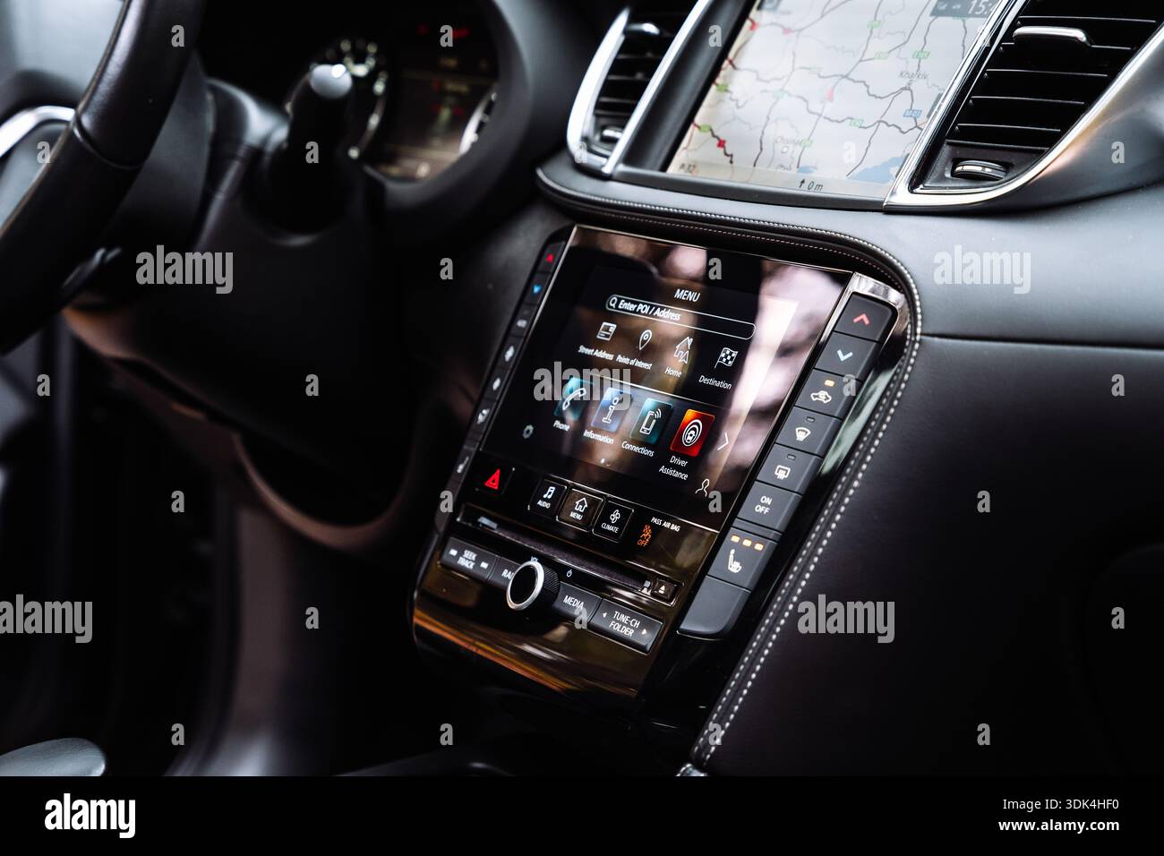 Close-up view of a car infotainment touchscreen showing navigation map ...