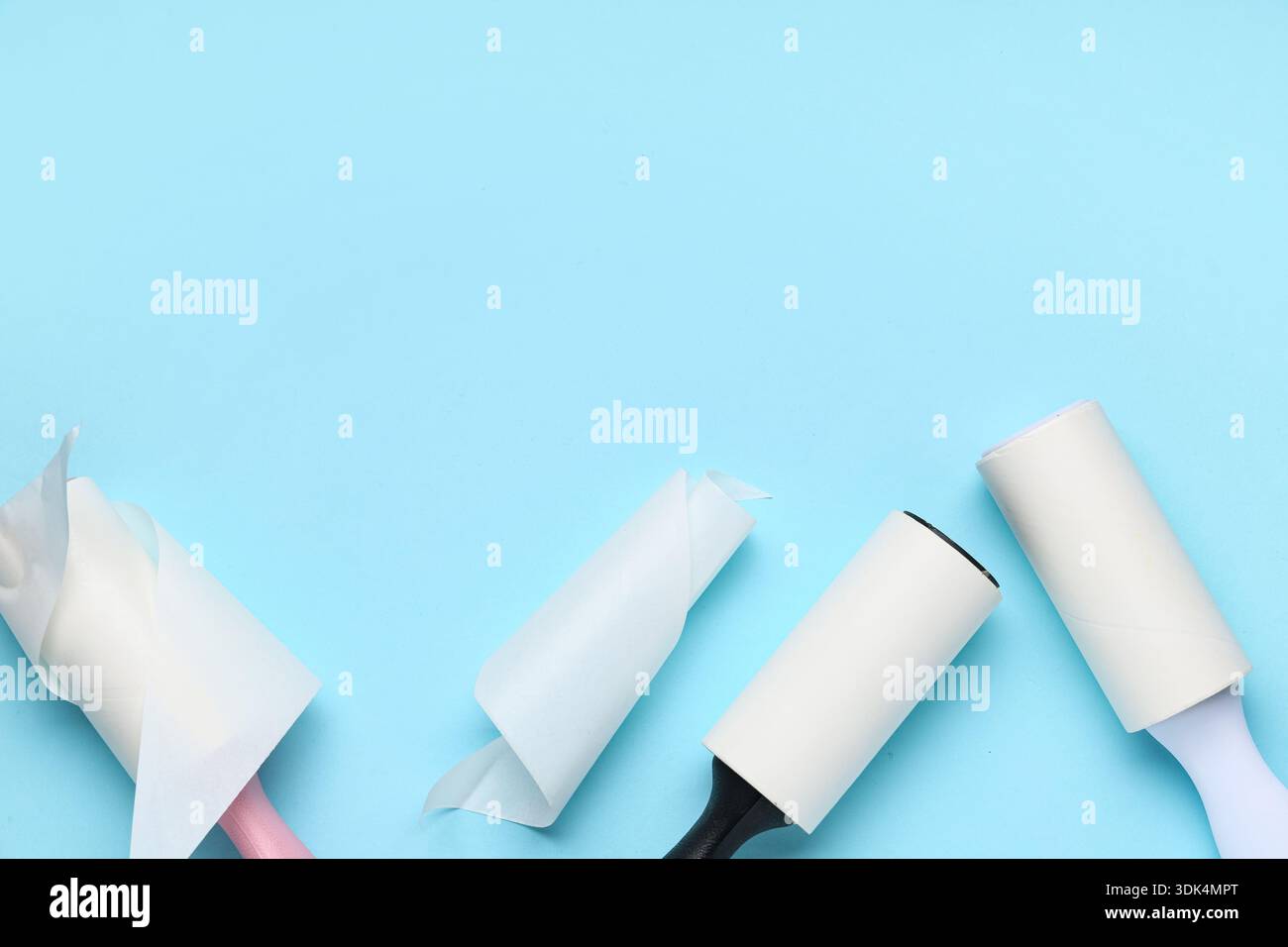Sticky lint rollers on blue background Stock Photo