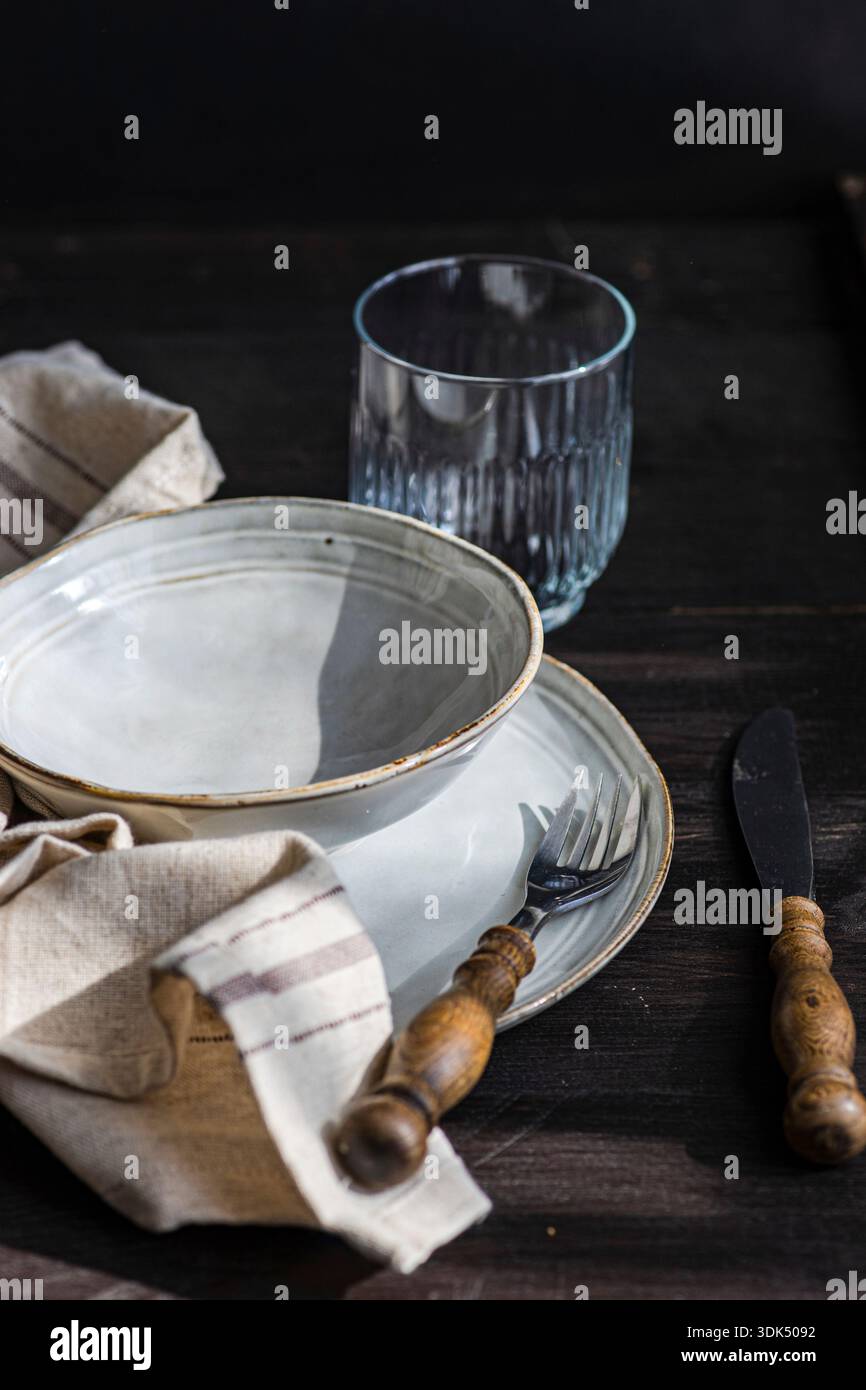 Rustic place setting with bowl and cutlery Stock Photo