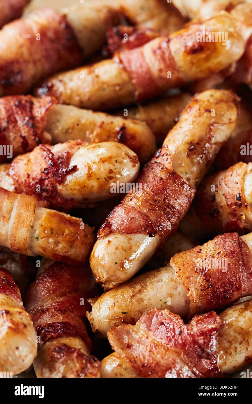 Sausages wrapped in bacon Stock Photo