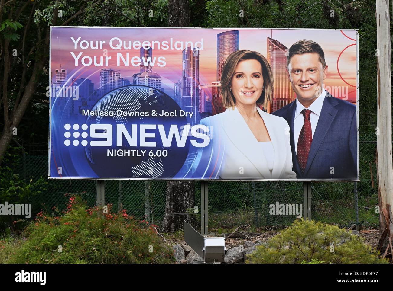 A billboard depicting newsreaders Melissa Downes and Joel Dry is seen — free download