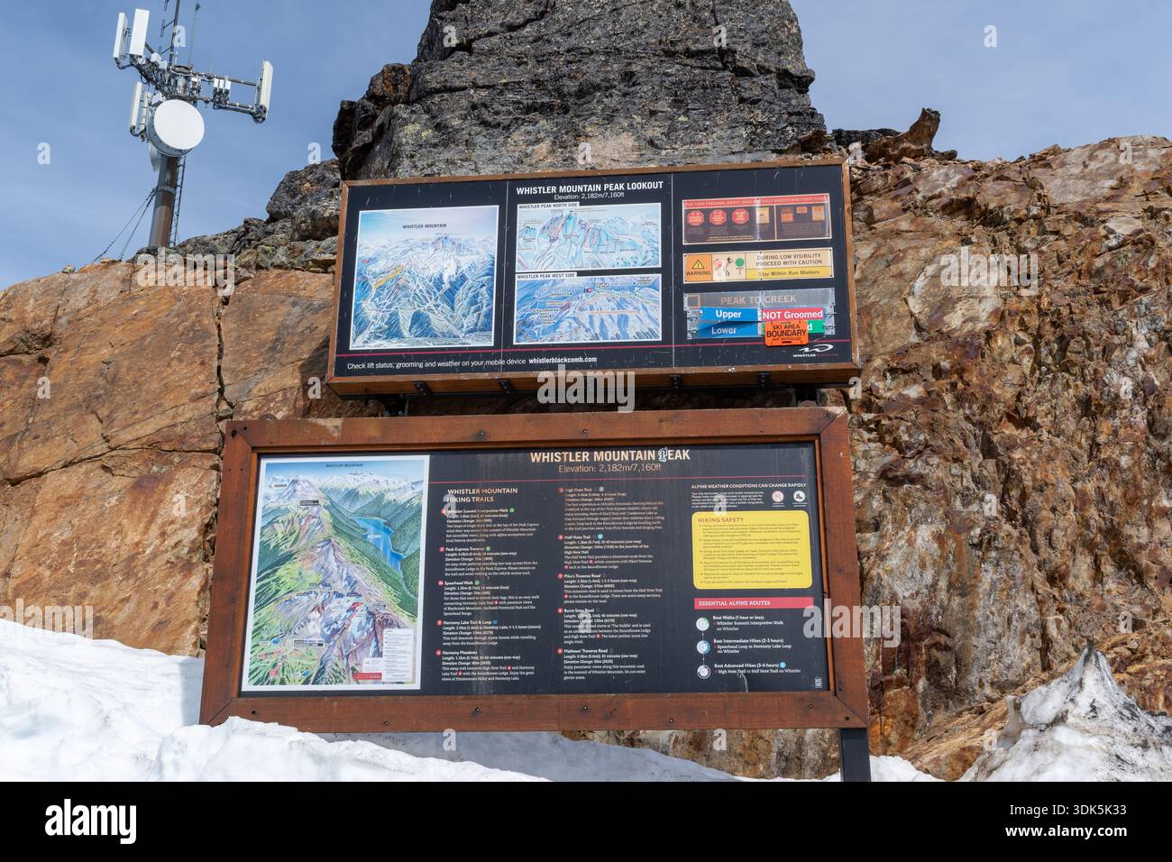 Whistler, BC  Canada - 21 JUN 2024: Two informational signs mark the Whistler Mountain Peak Lookout, set in snowy ground with a rocky backdrop. Stock Photo