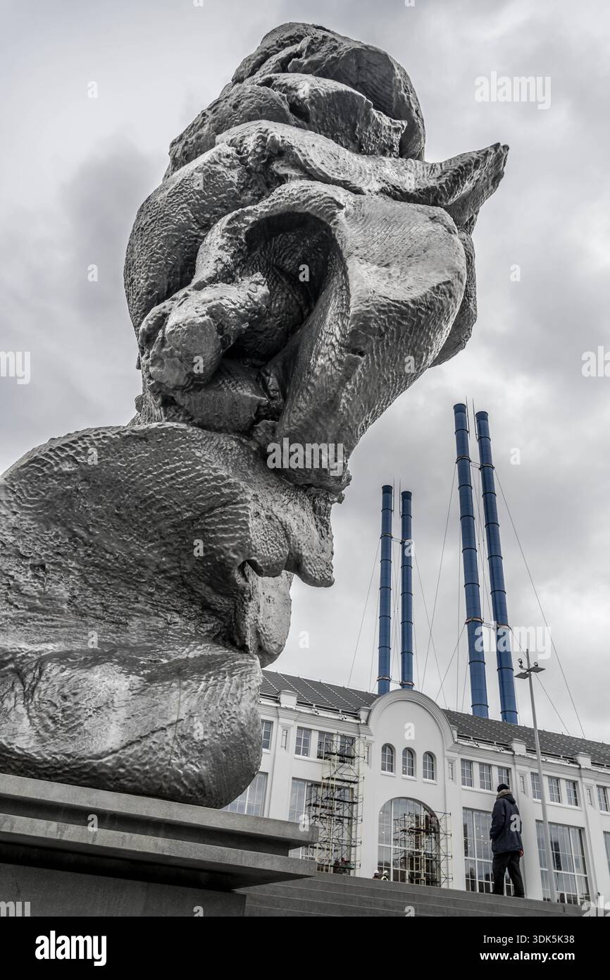 Big Clay culpture by Urs Fischer on Bolotnaya Embankment along Moskva River amid pedestrians and boats, Moscow, Russia, vertical photo. Stock Photo