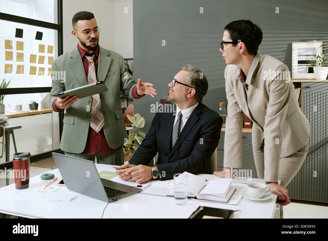 Multiethnic Business Team Discussing Project Strategy in Modern Office Stock Photo