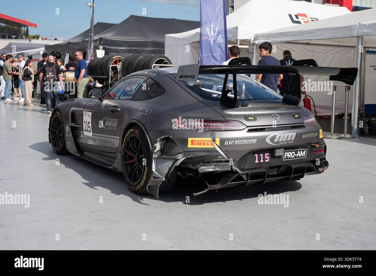 Rear view of a gray Mercedes-AMG GT2 race car with a heavily damaged ...