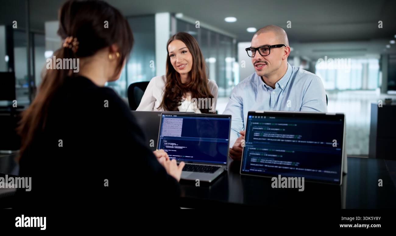 Innovative Software Engineers Collaborate In Diverse Office Environment Developing Codes. Stock Photo