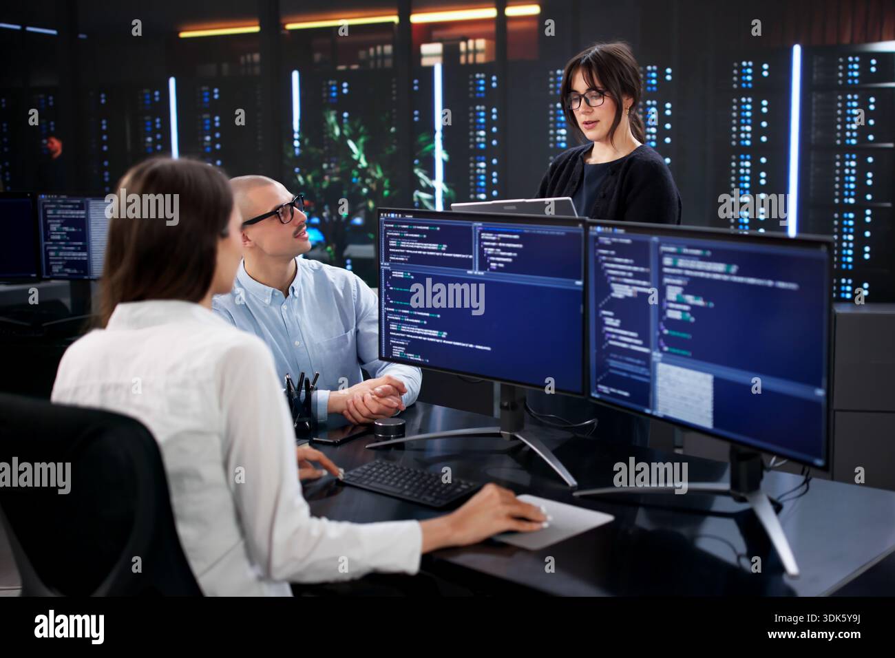 Multicultural Team Of Software Developers Coding Business Data On Computers Stock Photo