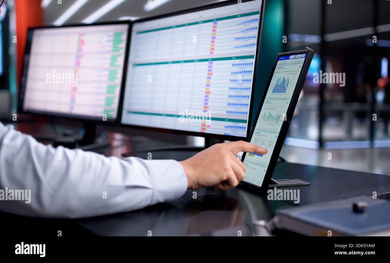 Analyzing Business Data On Computer, Financial Advisor Reviews Spreadsheet Analysis. Stock Photo