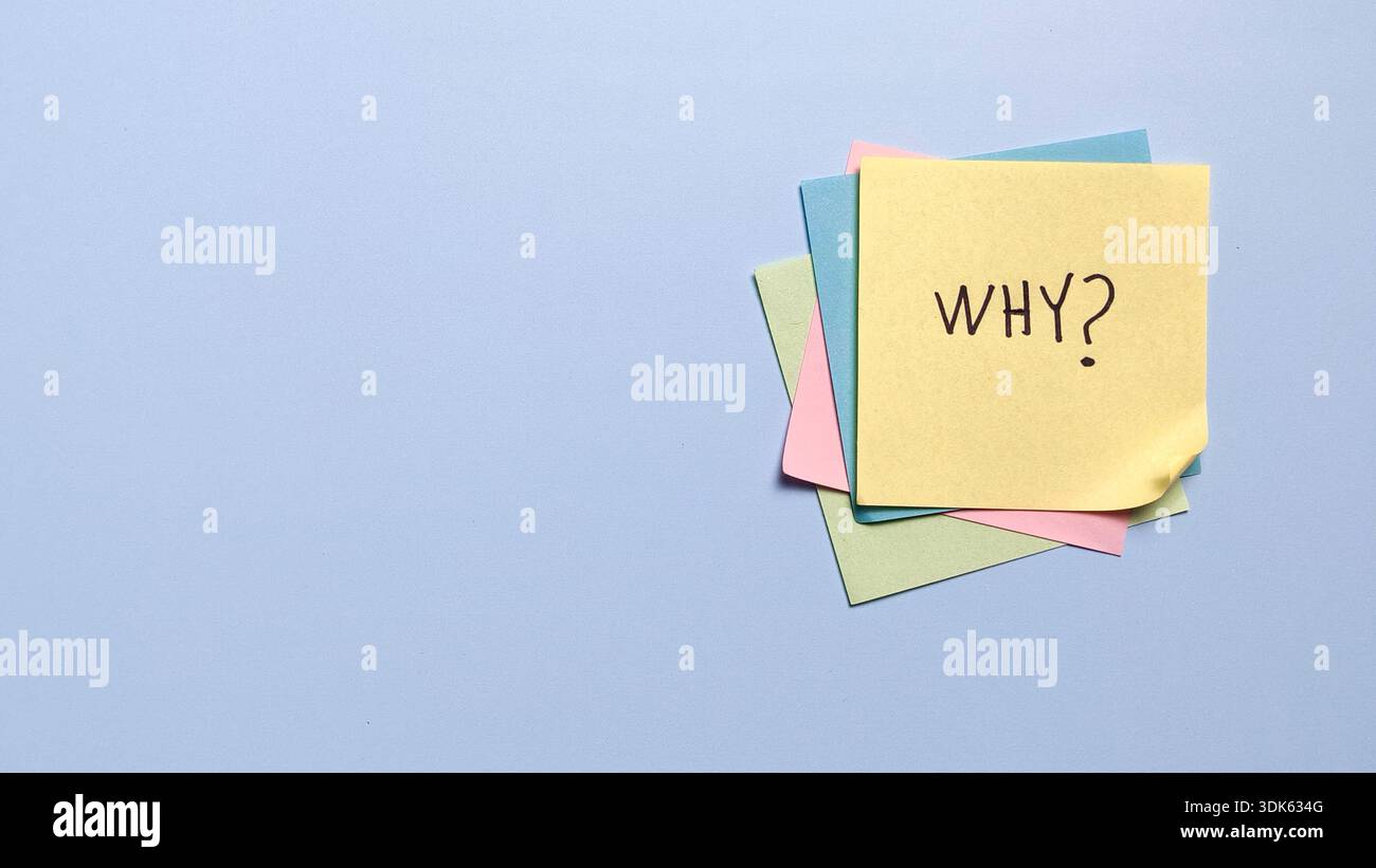 Stack of colorful sticky notes with handwritten why text for brainstorming and creative problem solving Stock Photo