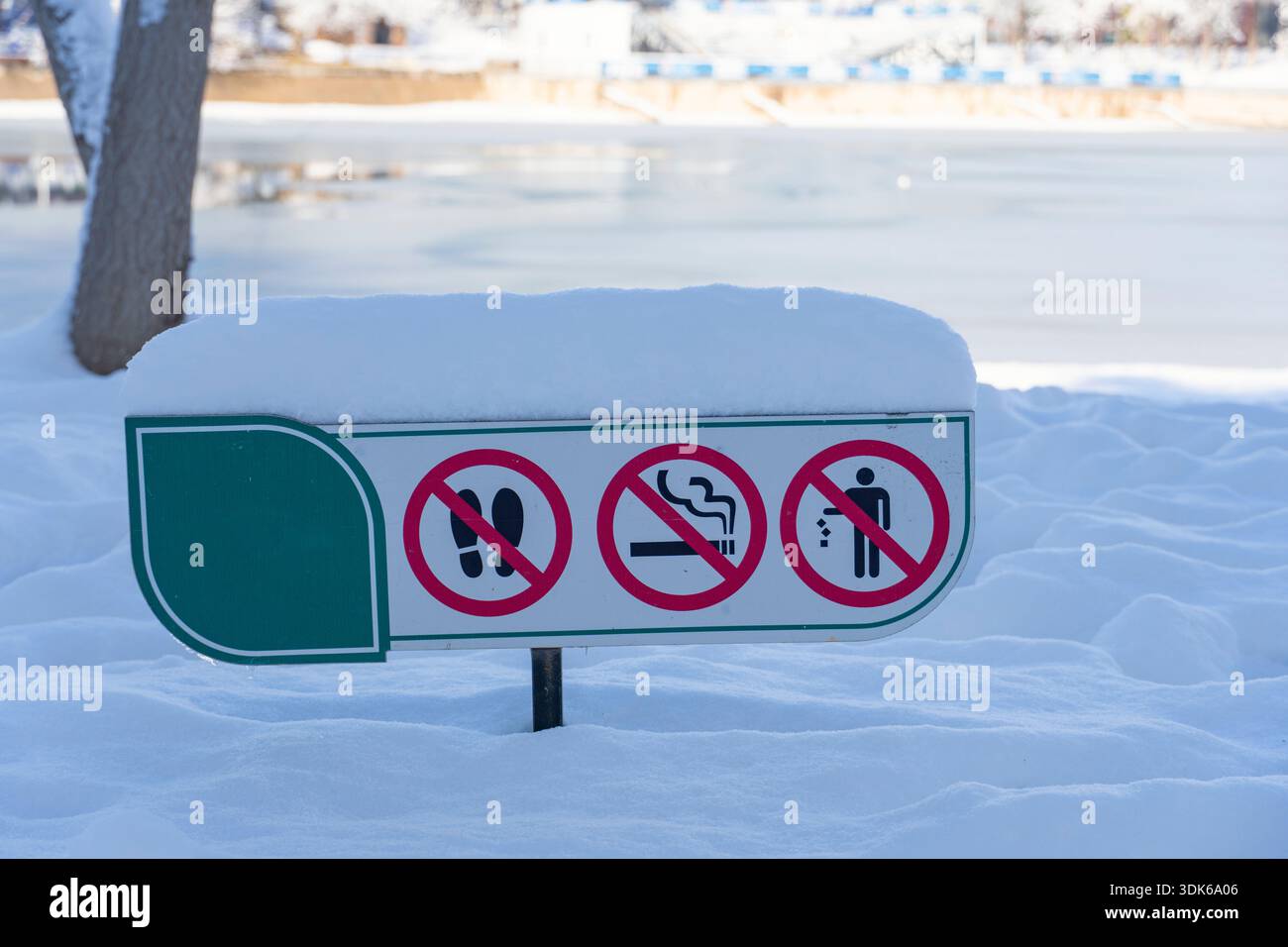 Outdoor sign with prohibition symbols for walking, smoking, and ...