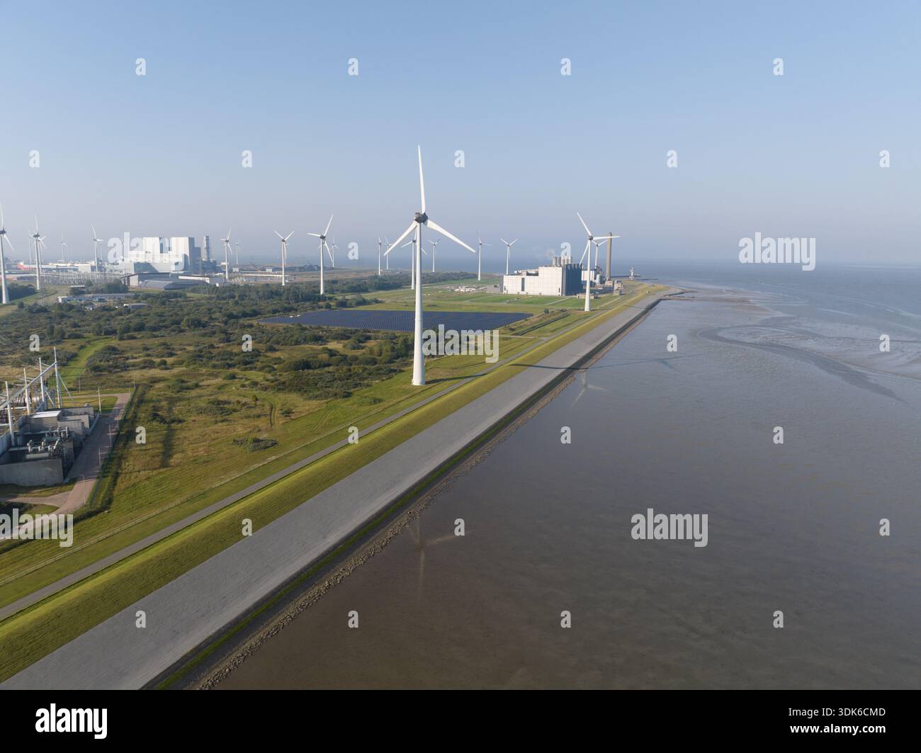 Wind turbines and power plant generating renewable energy Stock Photo ...