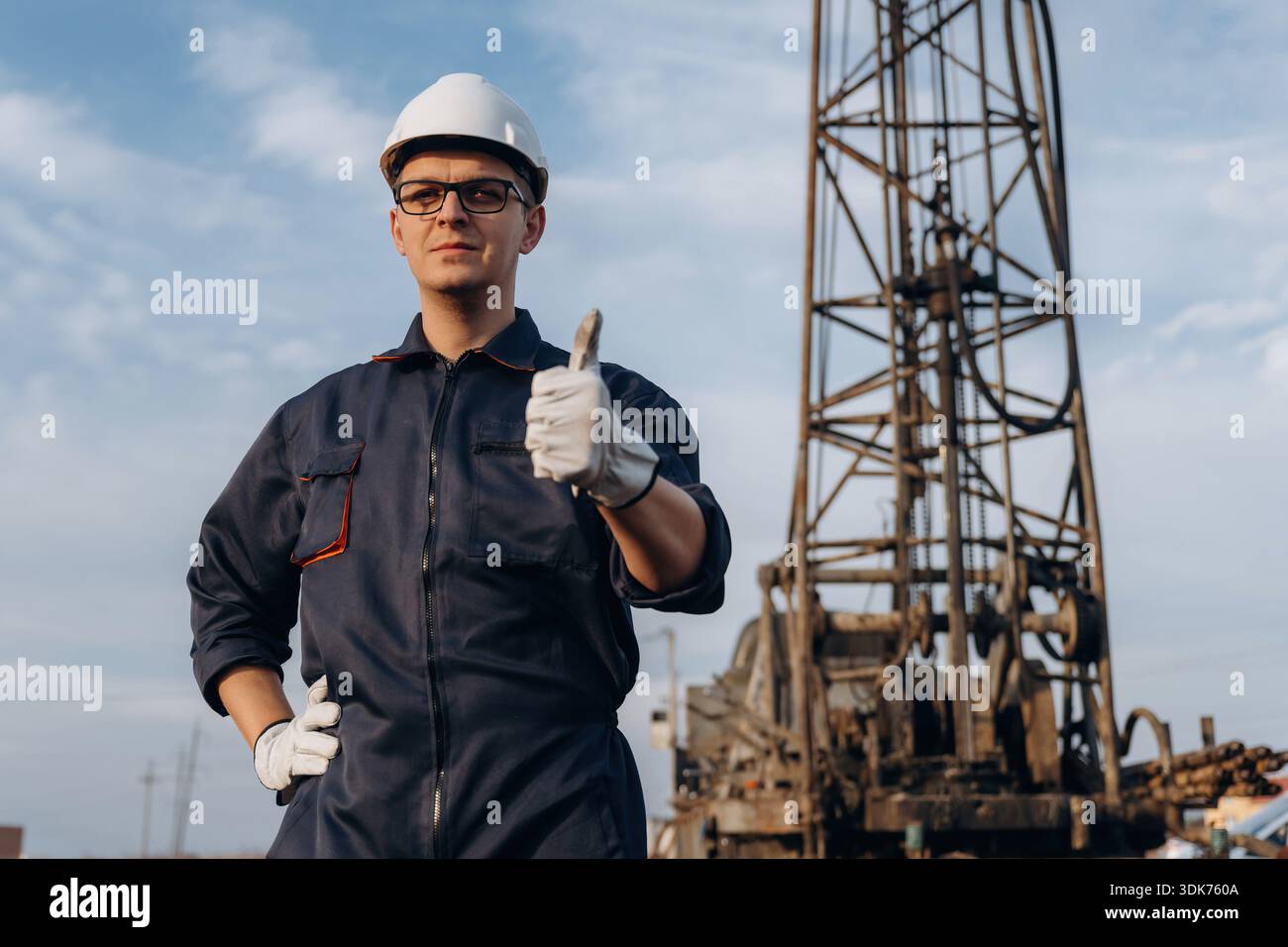 Thumb up gesture. Construction worker is near boring drilling machine. Stock Photo