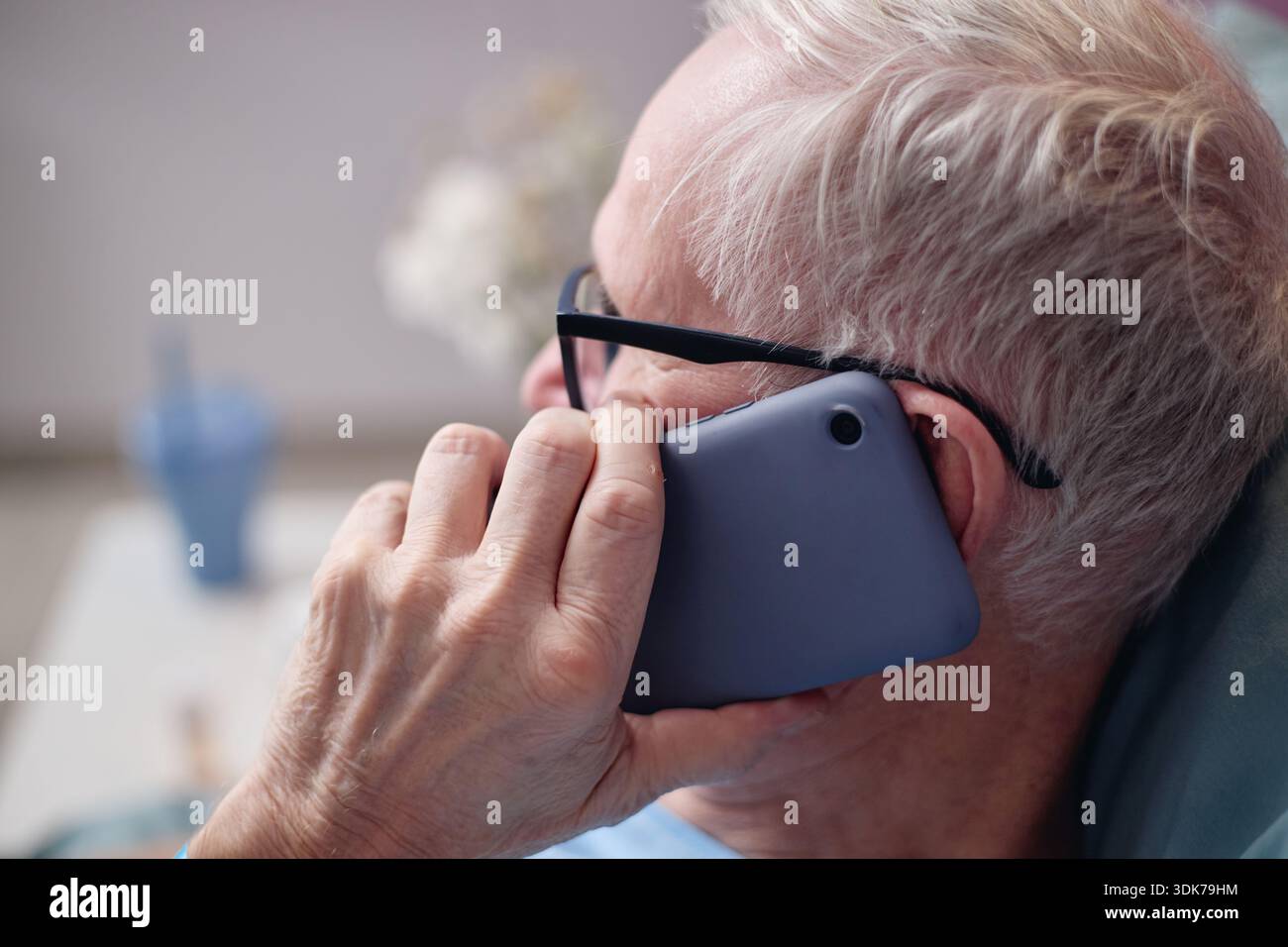Senior Man Talking on Smartphone While Resting at Vascular Center Stock Photo