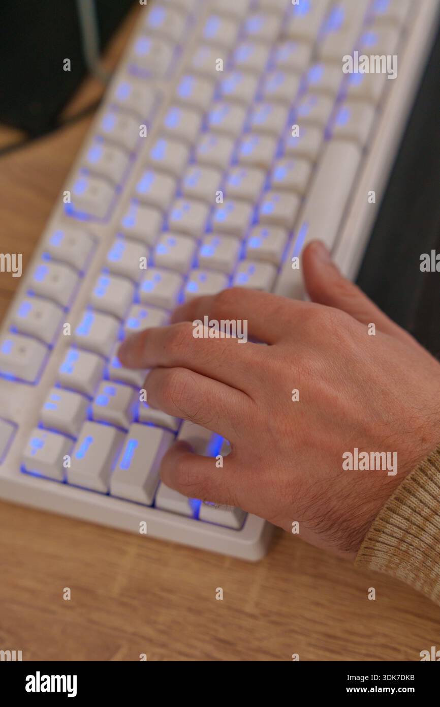 Person working on 3D animation at desk with graphics tablet and mechanical keyboard Stock Photo