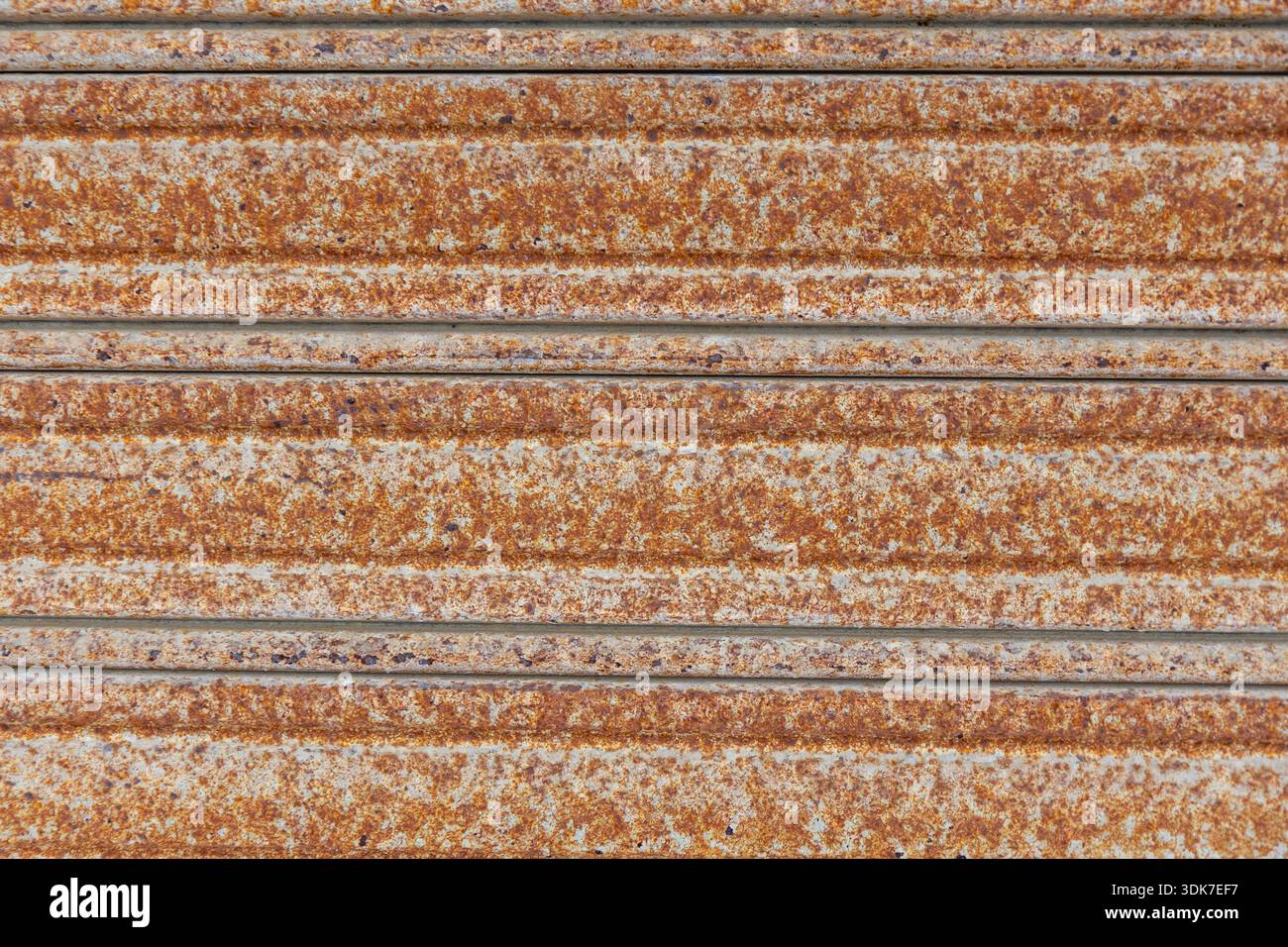 Iron Ridges Texture Close-up of a rusted corrugated metal surface with heavy oxidation ...