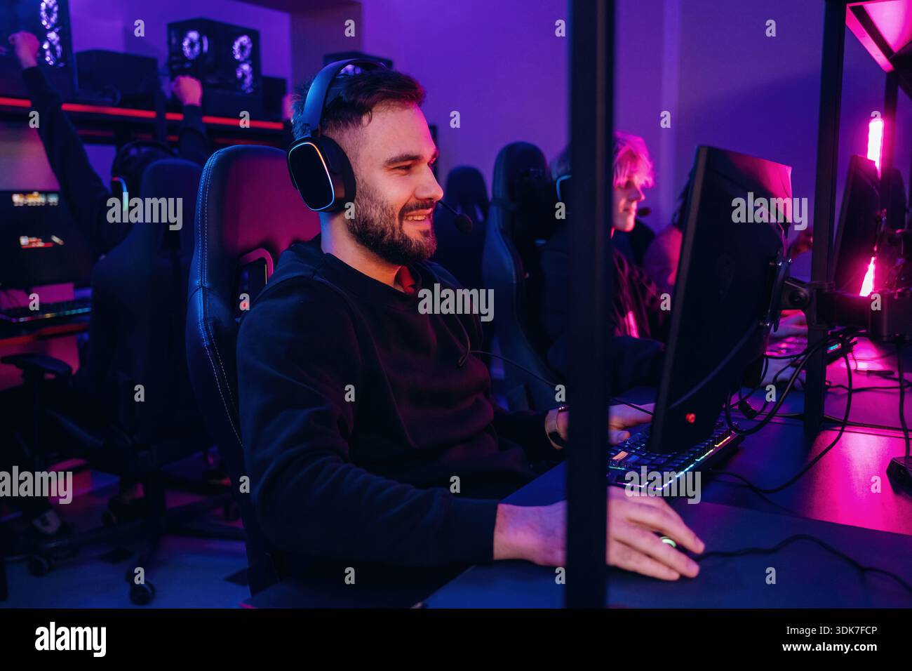 Using keyboard and mouse. Gamers are playing video game by computers ...