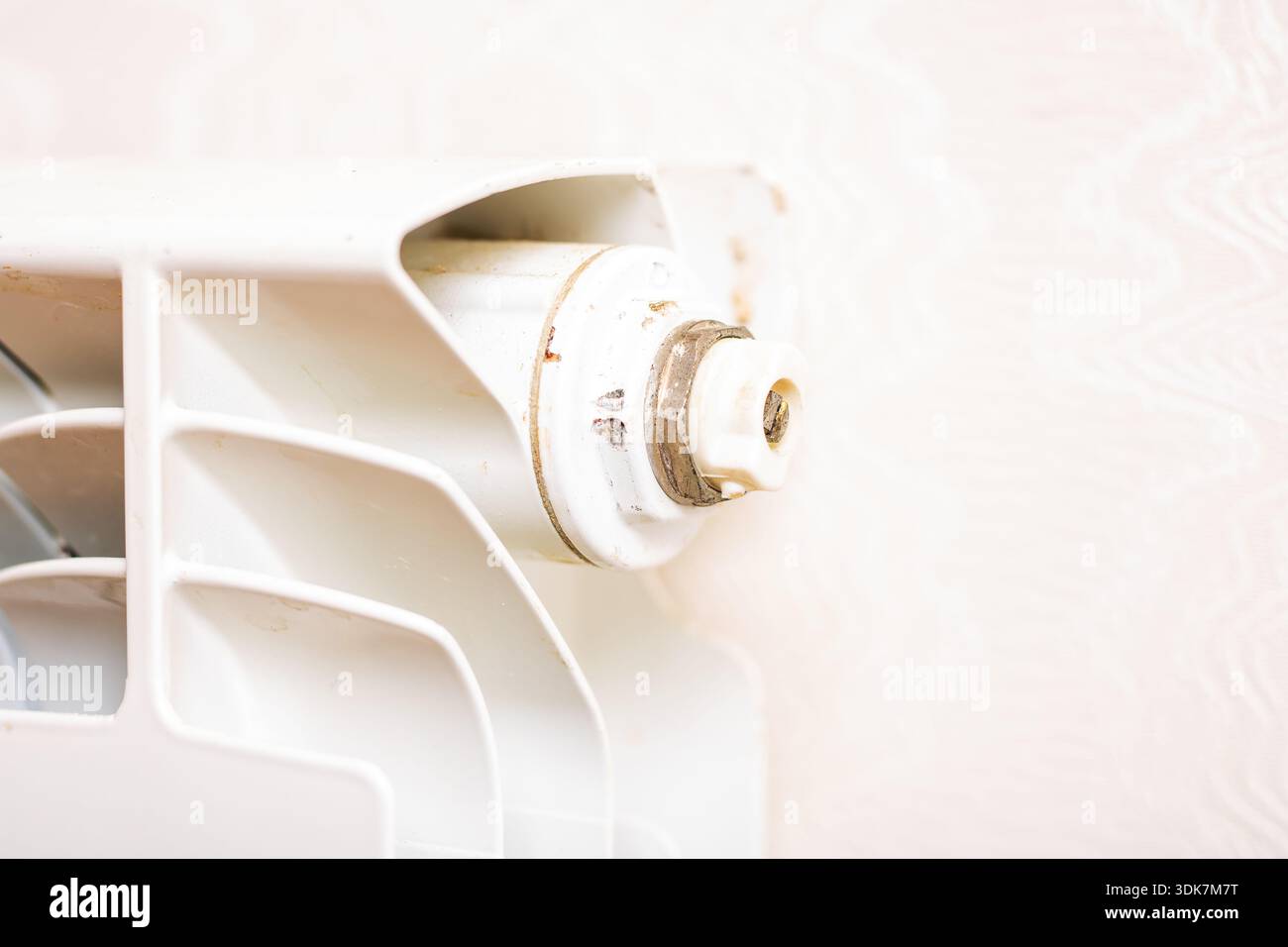 white radiator valve closeup revealing rust specks, chipped paint ...