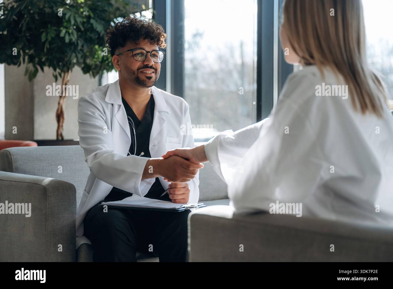 Photo Session Doctor Therapy session with doctor, sitting. Man and woman are indoors in ...