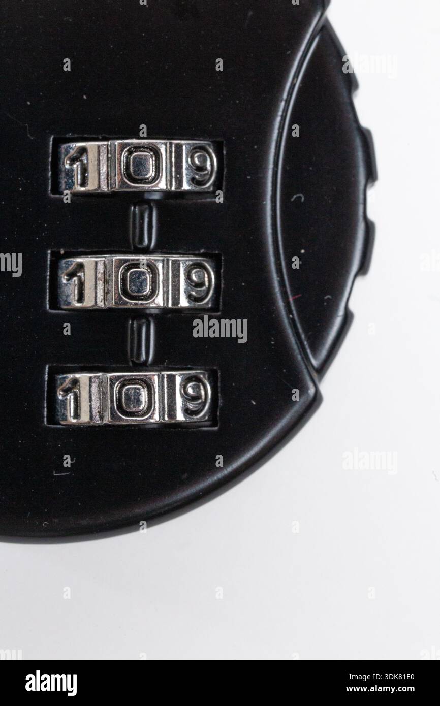 Close-up of black combination lock with code on white background. Stock Photo