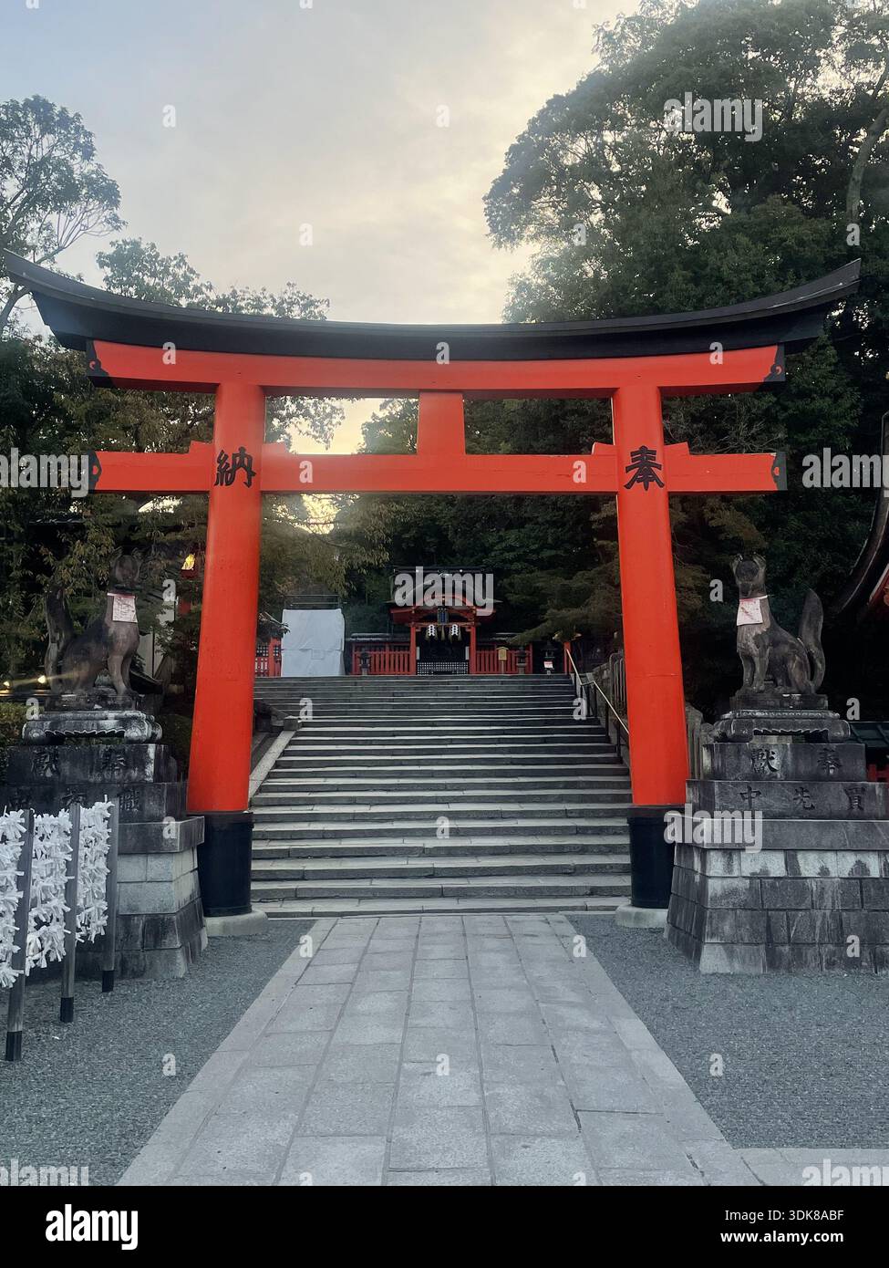 View of a vibrant red torii gate standing majestically before stone ...