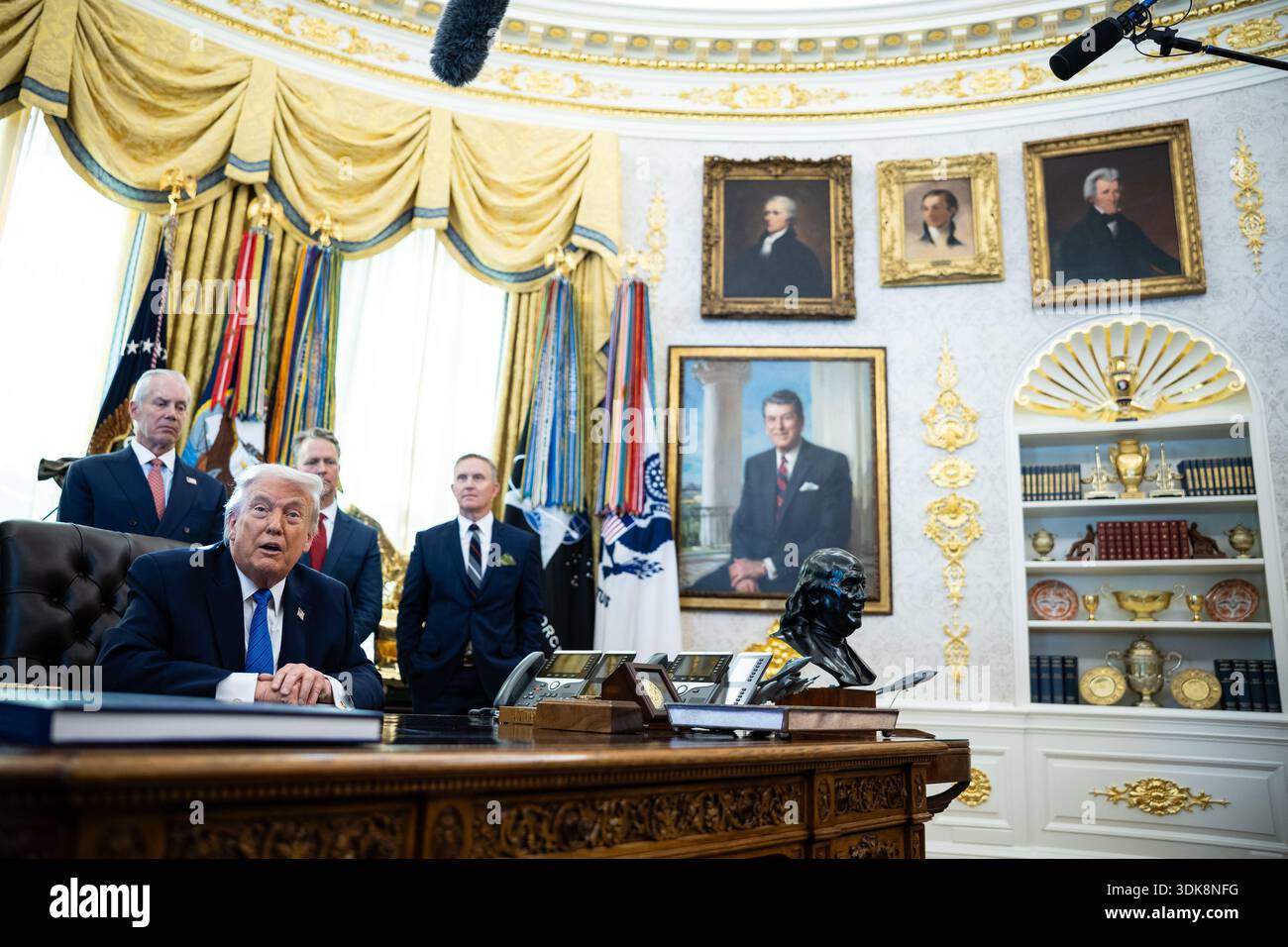 President Donald Trump signs executive orders in the Oval Office at the