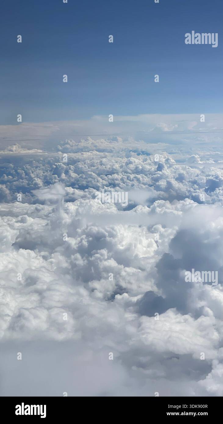 Cloudscape viewed from an airplane window during flight over Central America. Stock Photo