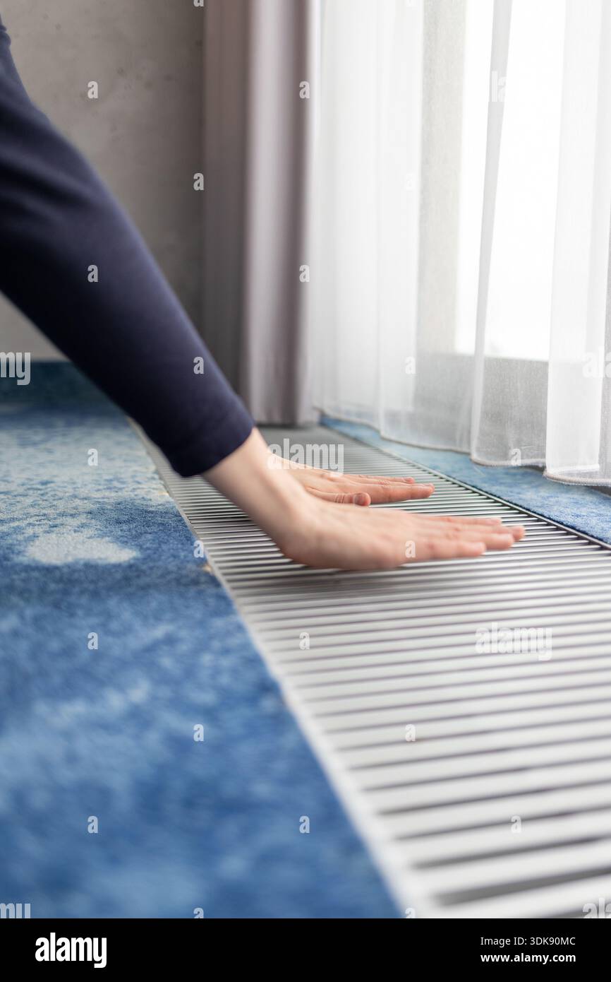floor convector radiator near a window. Underfloor heating system ...