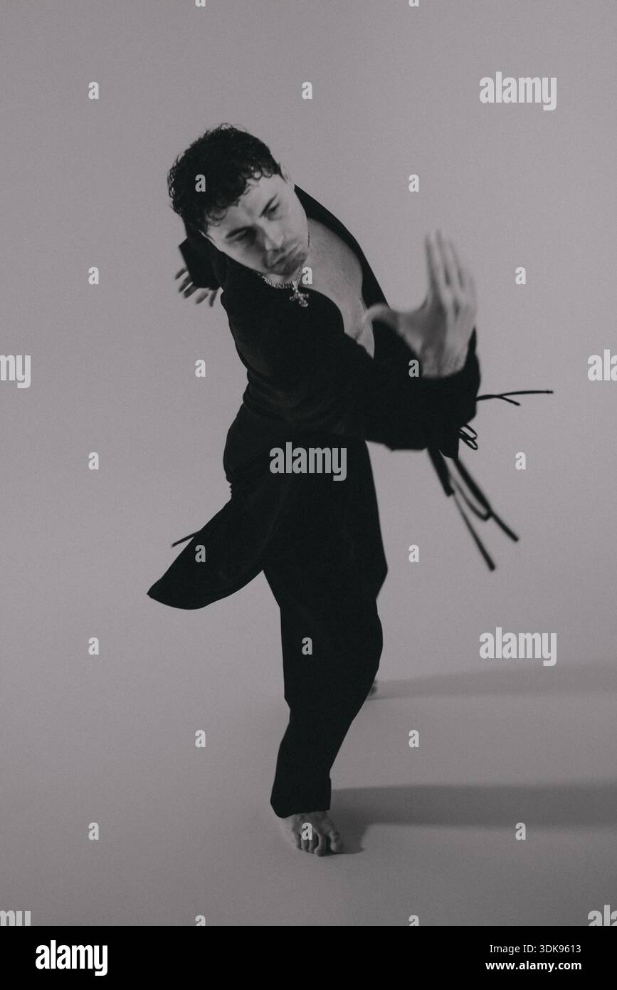 Stark setting showcasing performer immersed in energetic dance Stock Photo