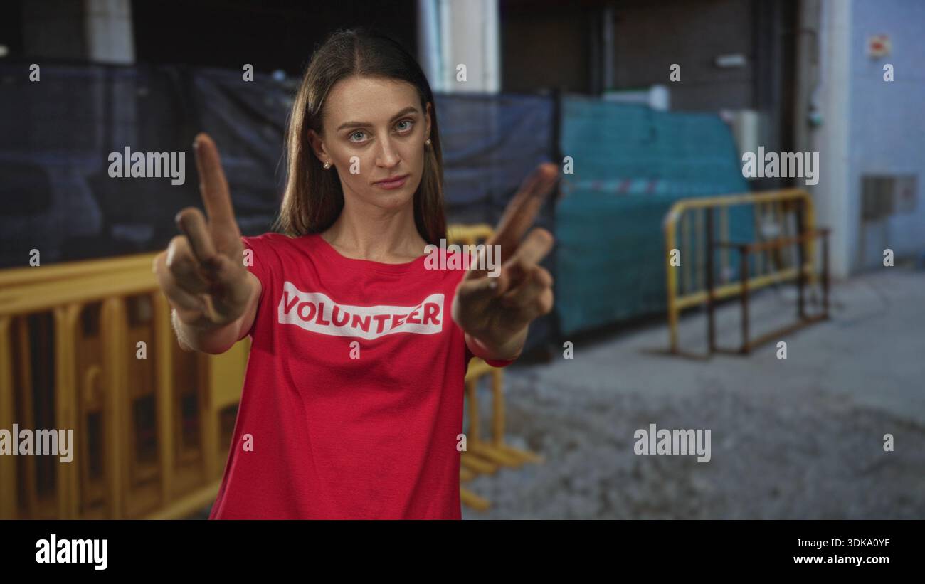 Red Finger Building Woman points fingers forward in building wearing red volunteer shirt ...