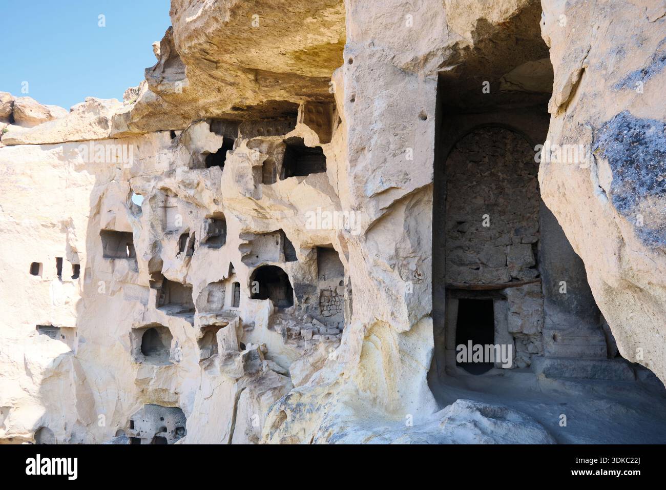 Ancient rock-cut dwellings carved into cliff face Stock Photo - Alamy