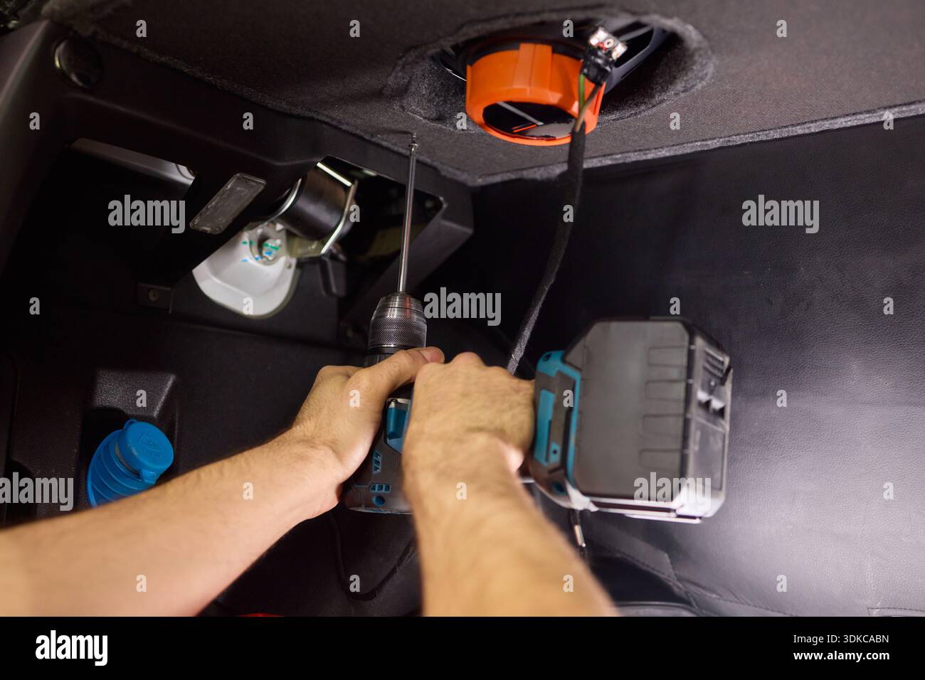 L Connection Mechanic Technician fixing dashboard connector. Closeup of electrical connection ...