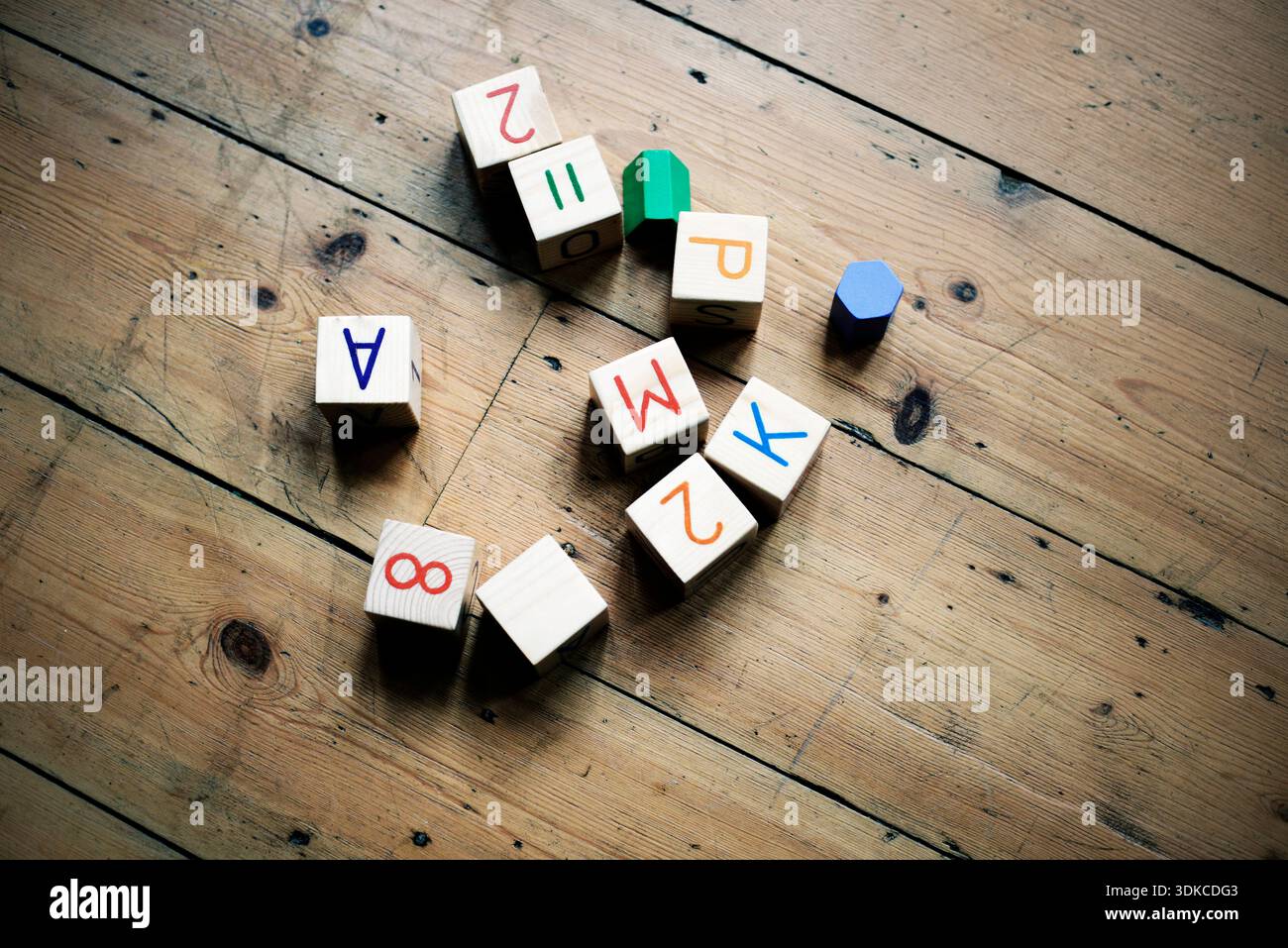 Childs play blocks on wooden floor Stock Photo