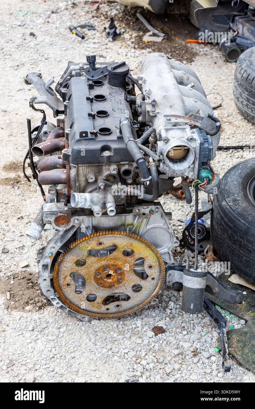 A scrapped four cylinder engine sits in the LKQ Pick Your Part auto ...