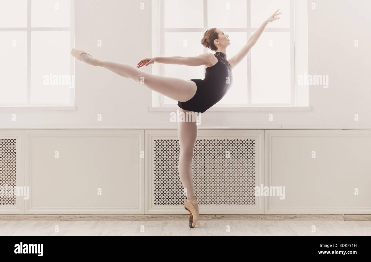 Beautiful woman ballerina in arabesque ballet position Stock Photo
