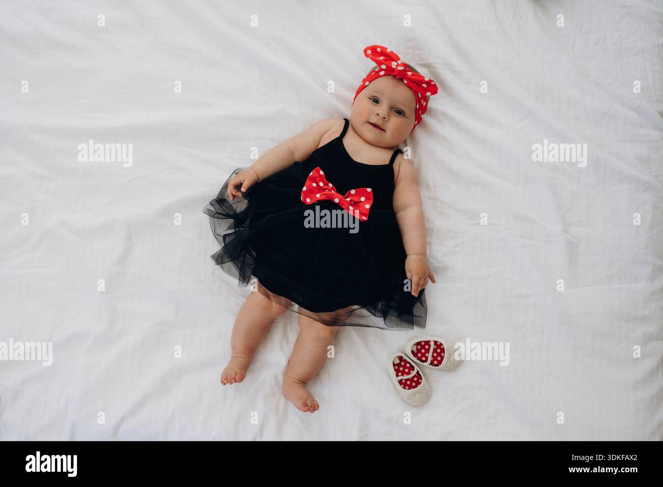 Top view of cute newborn baby girl that is lying down and in black dress  Stock Photo - Alamy