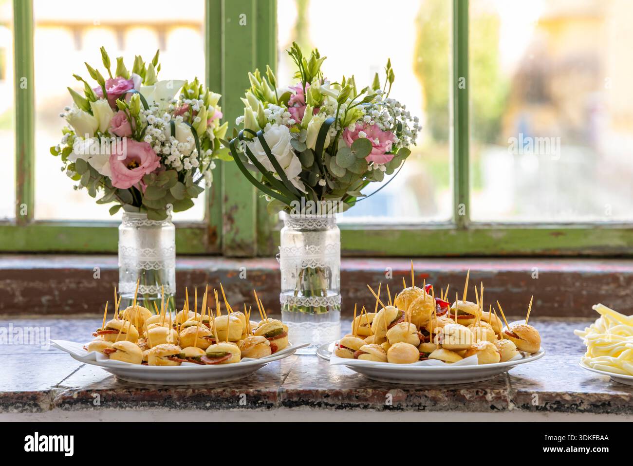 Appetizers and flowers decorating a table for a celebration Stock Photo