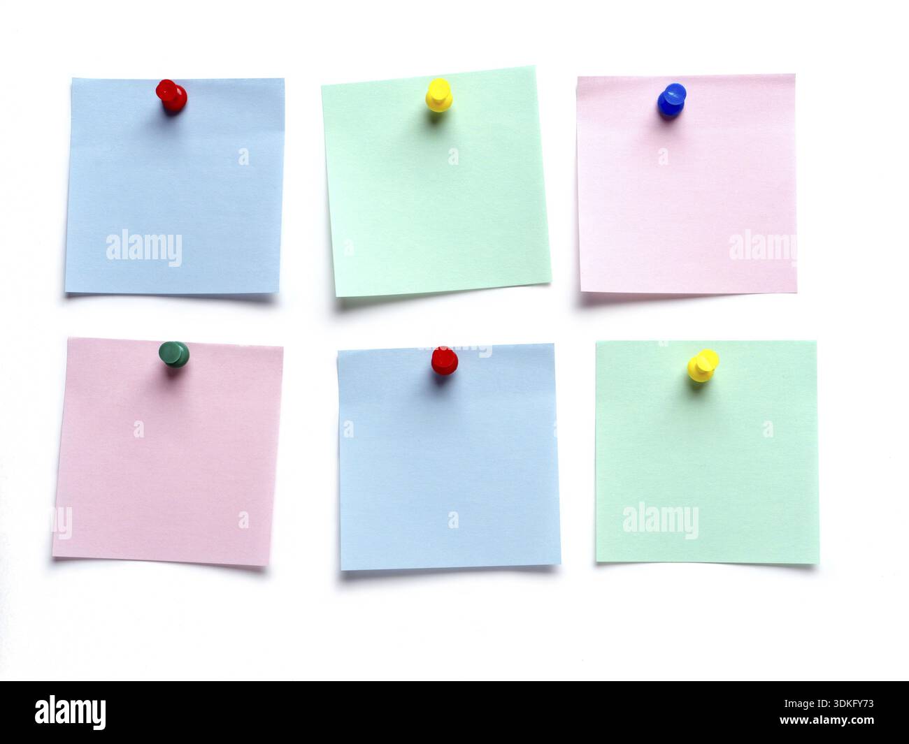Six blank post-it notes pinned on white surface Stock Photo