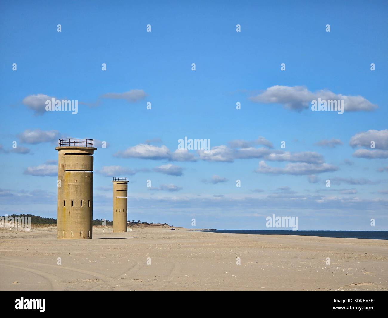 World War II concrete observation towers on a quiet sandy beach under a bright blue sky along the Atlantic coast. - Smartphone Captured Stock Image