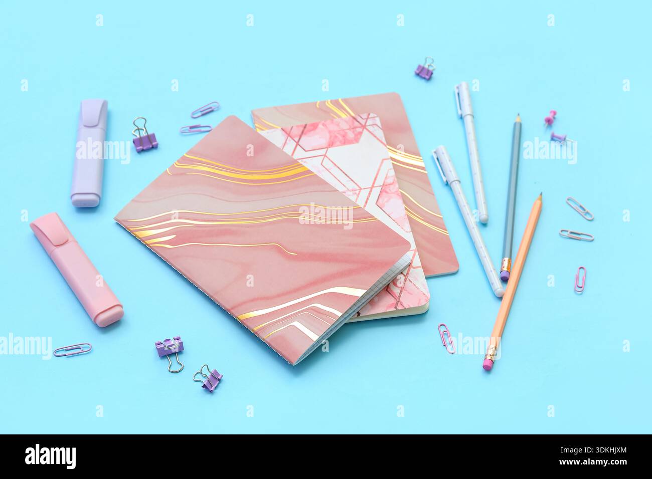 Composition with notebooks and different stationery on color background Stock Photo