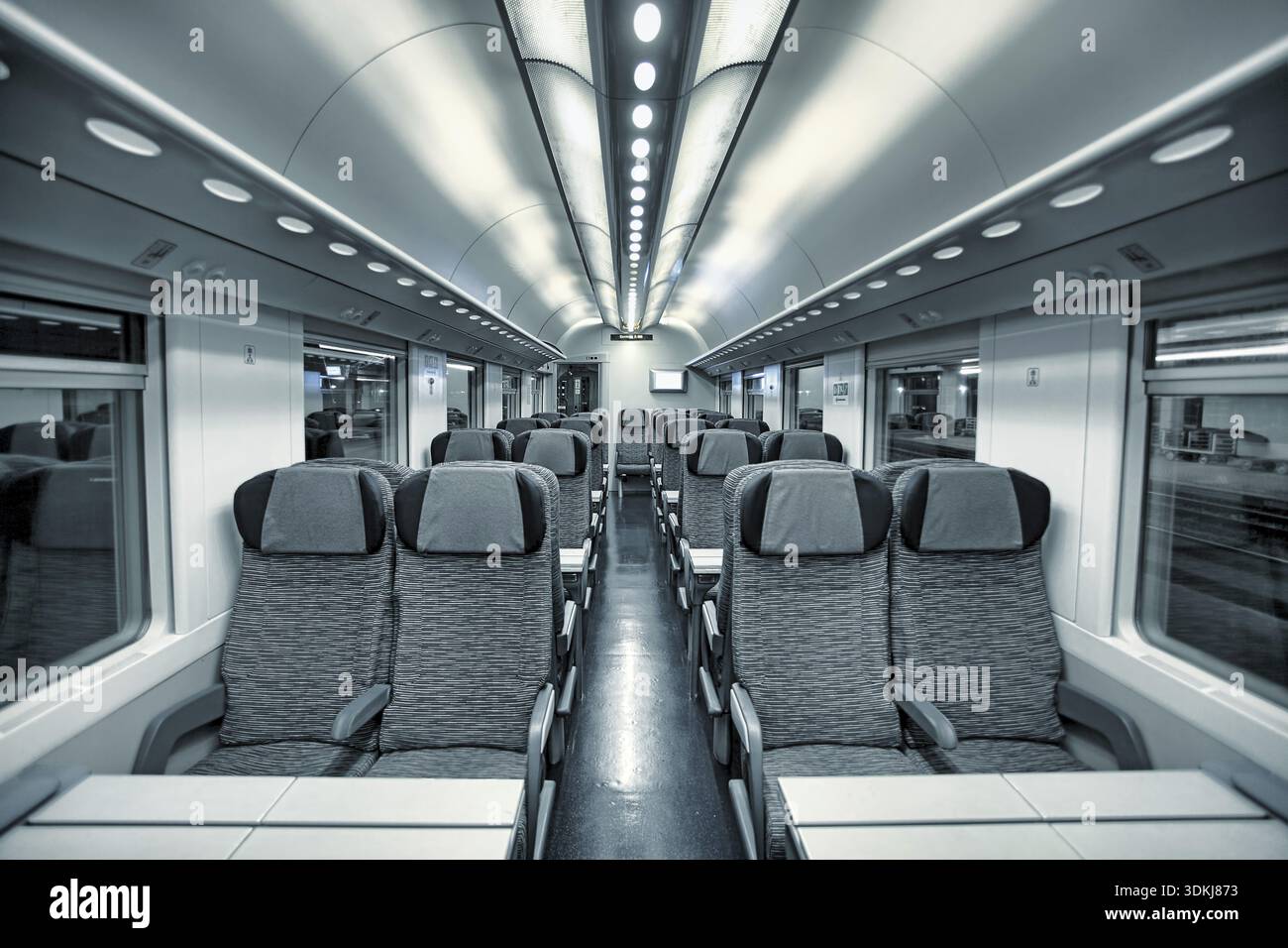 Interior view of modern intercity high speed train coach with rows